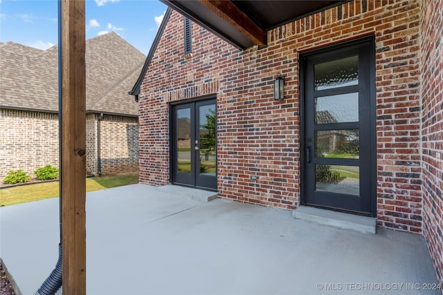 view of exterior entry featuring french doors