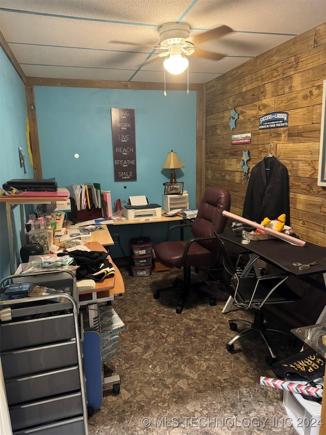 office with ceiling fan and wooden walls