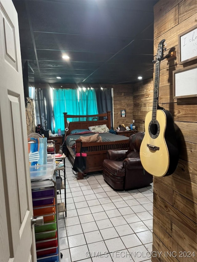 bedroom featuring wooden walls