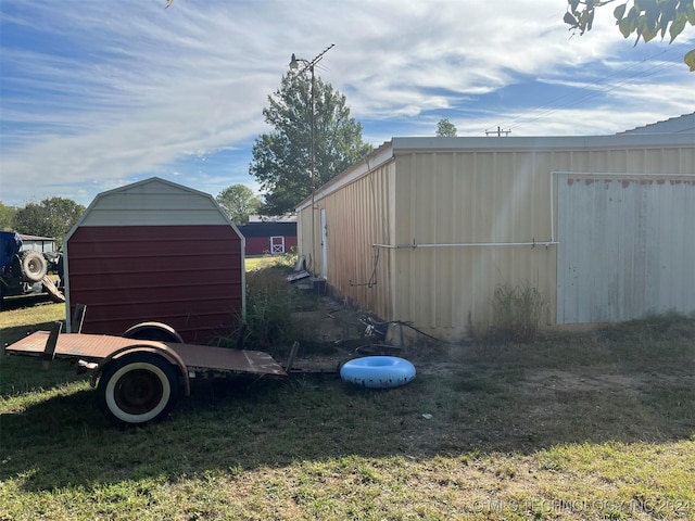 exterior space with an outbuilding and a lawn