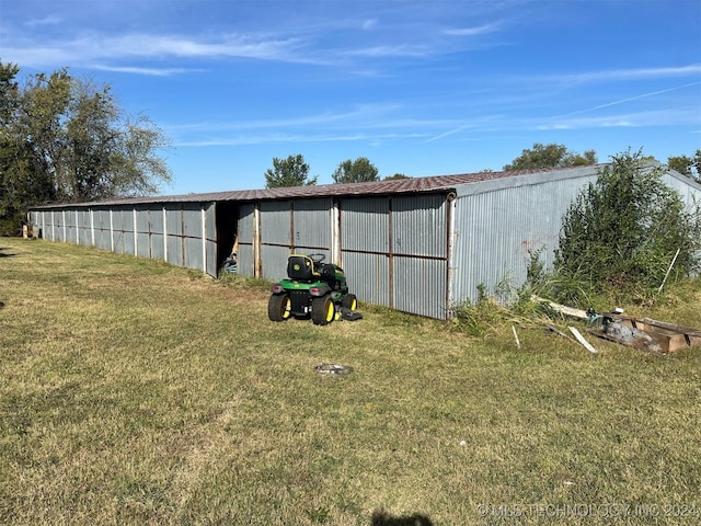 view of outbuilding with a yard