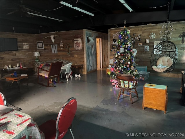 interior space featuring concrete flooring and wooden walls