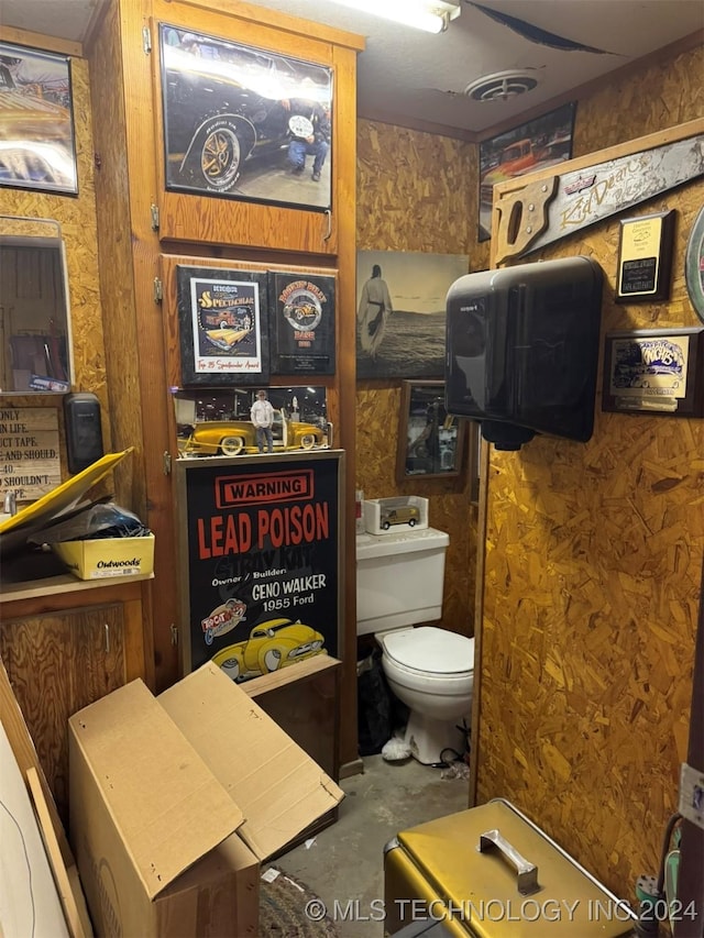 bathroom with concrete flooring and toilet