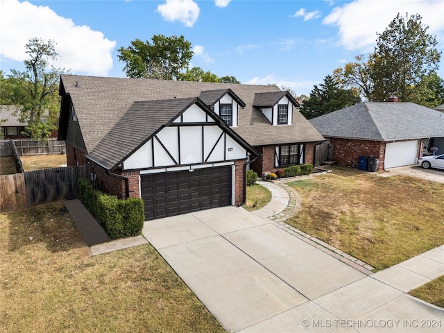 view of front of house featuring a garage and a front lawn