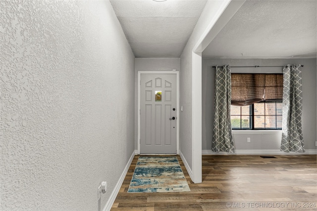 entrance foyer featuring wood-type flooring and a textured ceiling