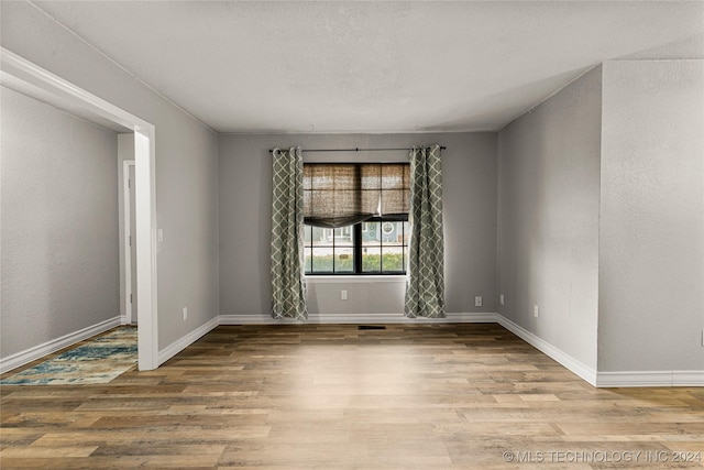 empty room with light hardwood / wood-style flooring