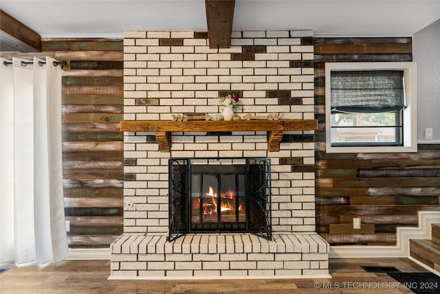 details featuring rustic walls, a fireplace, and hardwood / wood-style flooring