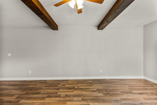 unfurnished room featuring beam ceiling, ceiling fan, wood-type flooring, and a textured ceiling