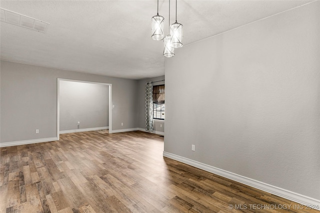 interior space with an inviting chandelier and hardwood / wood-style flooring