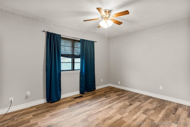 spare room featuring ceiling fan, a textured ceiling, and hardwood / wood-style flooring