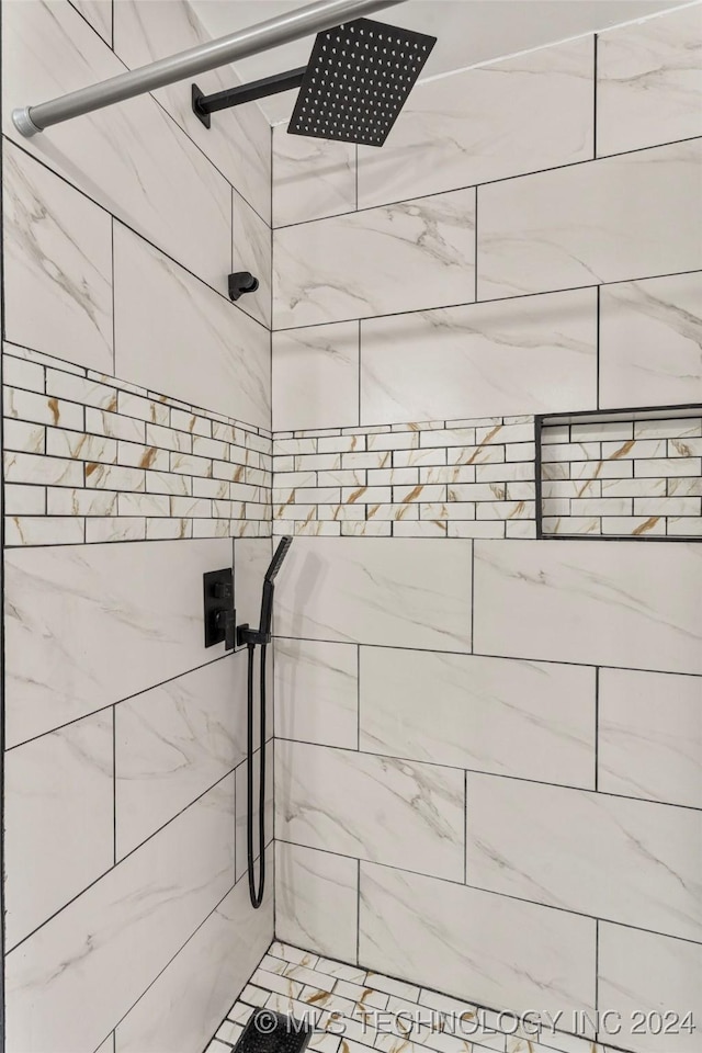 interior details with a tile shower