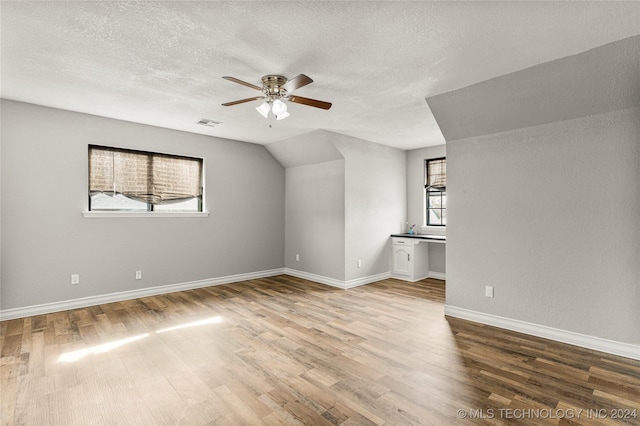 bonus room with ceiling fan, hardwood / wood-style floors, a healthy amount of sunlight, and vaulted ceiling