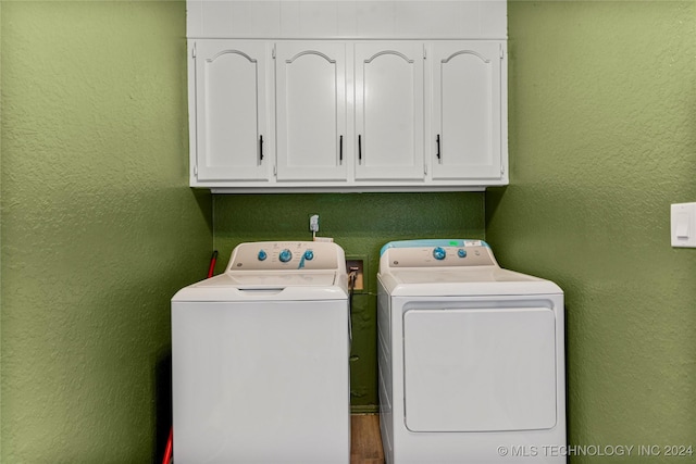 laundry area featuring cabinets and washing machine and dryer