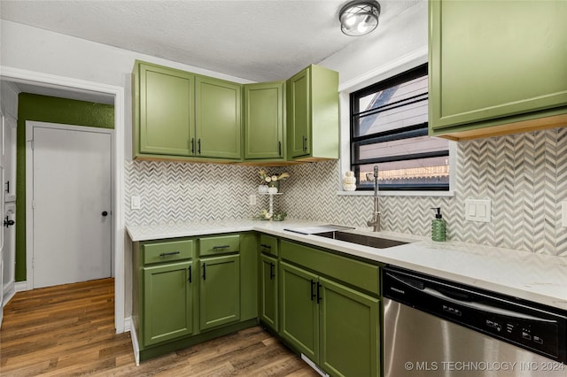 kitchen with sink, dishwasher, dark hardwood / wood-style floors, decorative backsplash, and green cabinetry