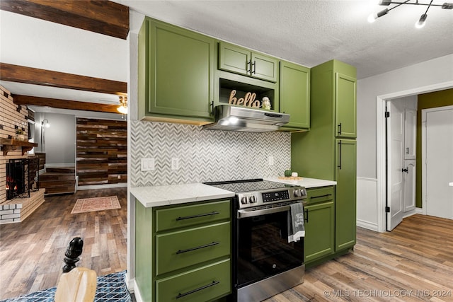 kitchen with electric range, dark hardwood / wood-style floors, green cabinets, and ventilation hood