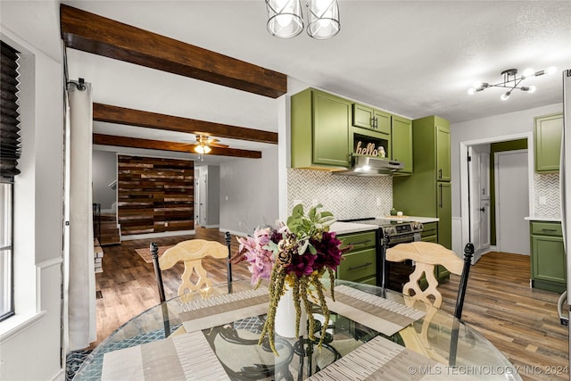 dining room with beam ceiling, ceiling fan, and dark hardwood / wood-style floors