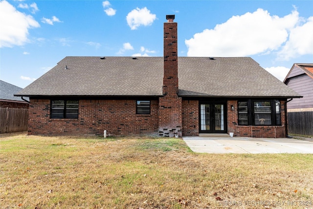 back of property featuring a patio area, a yard, and french doors