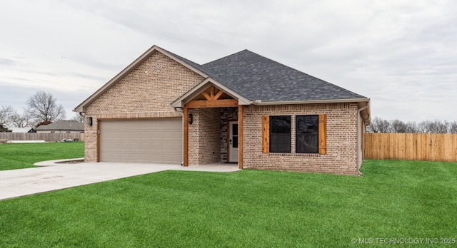 view of front facade with a front yard and a garage