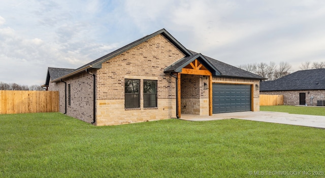 view of front facade with an attached garage, fence, concrete driveway, and a front yard