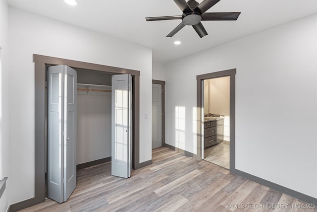 unfurnished bedroom featuring baseboards, a closet, light wood-type flooring, and recessed lighting