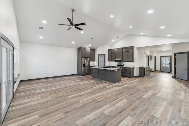 kitchen with high vaulted ceiling, visible vents, appliances with stainless steel finishes, and open floor plan