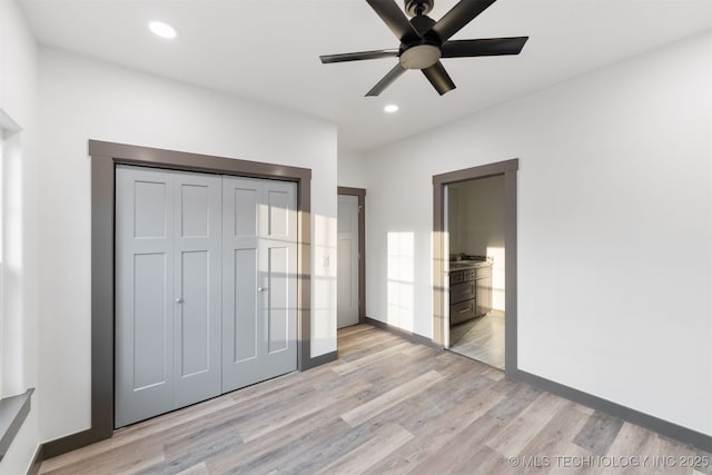 unfurnished bedroom with recessed lighting, a closet, baseboards, and light wood finished floors