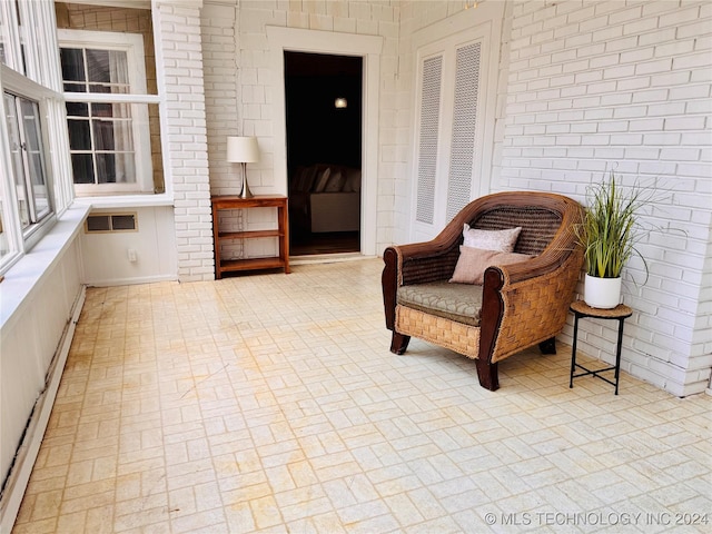 sitting room featuring brick wall