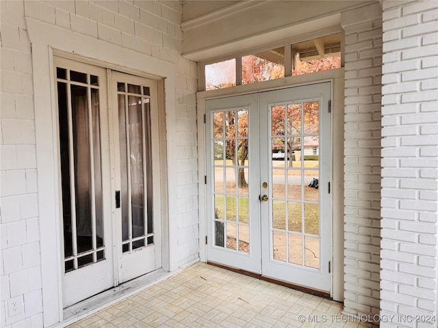 entryway with french doors and brick wall