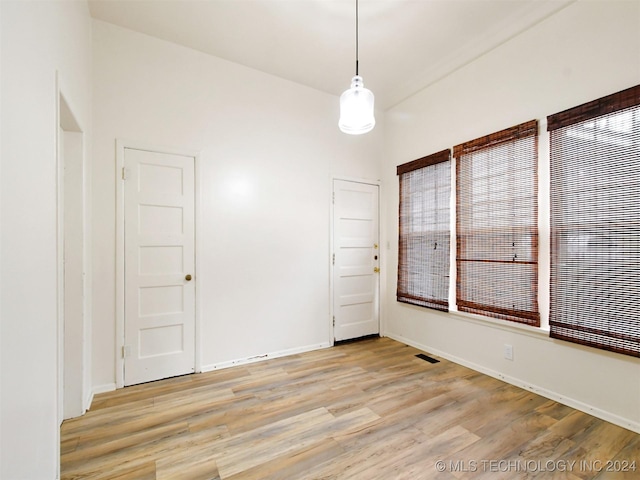 unfurnished room with light wood-type flooring