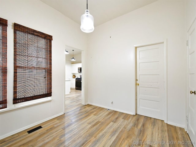 empty room with light hardwood / wood-style flooring