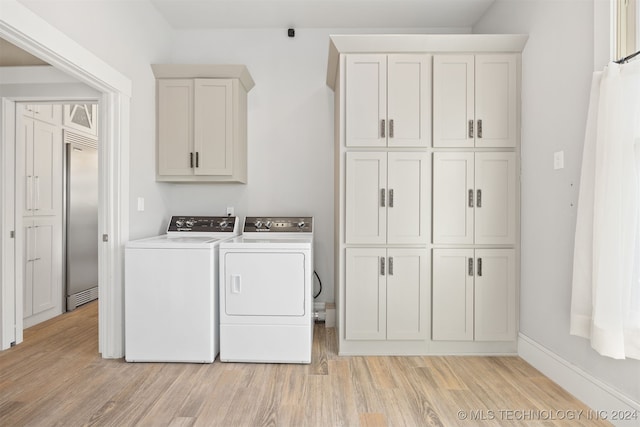 laundry area with cabinets, light wood-type flooring, and independent washer and dryer