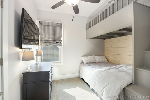 bedroom featuring light colored carpet and ceiling fan