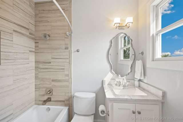 full bathroom with toilet, vanity, and tiled shower / bath combo