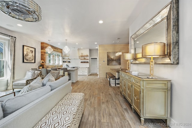 living room with sink, a healthy amount of sunlight, and light hardwood / wood-style floors