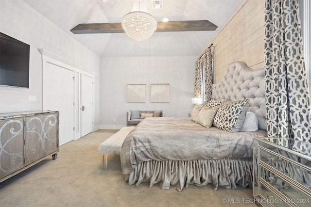 carpeted bedroom with a notable chandelier and vaulted ceiling with beams