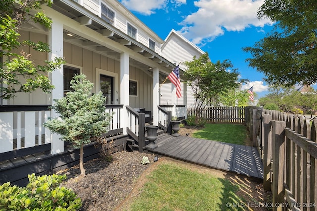 exterior space featuring covered porch and a yard