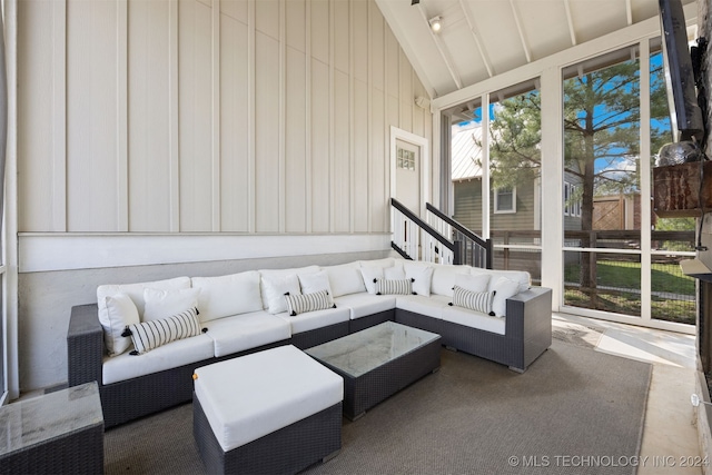 sunroom / solarium featuring lofted ceiling