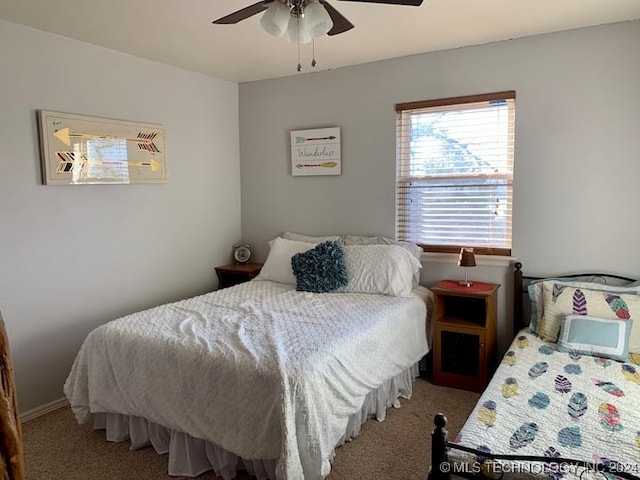 bedroom featuring ceiling fan and light carpet