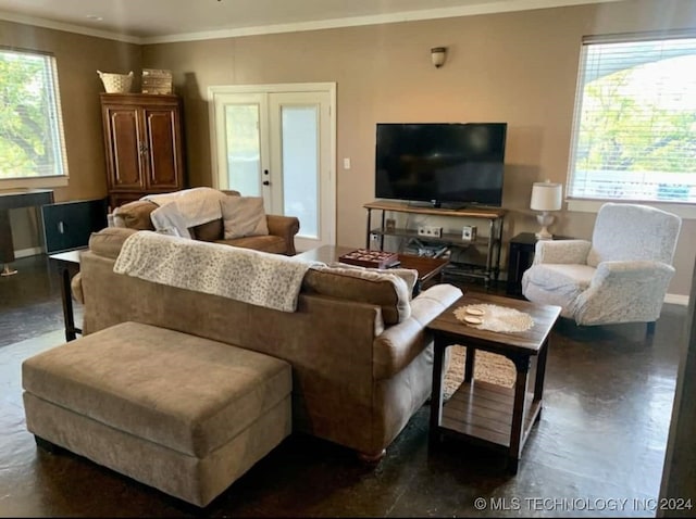 living room featuring french doors, a healthy amount of sunlight, and ornamental molding