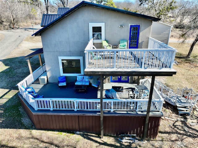 rear view of property featuring a deck