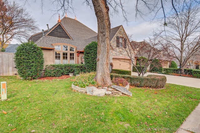 view of front of home featuring driveway, stucco siding, stone siding, and a front yard