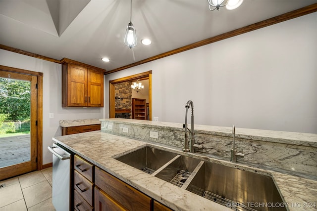 kitchen featuring light stone countertops, sink, stainless steel dishwasher, crown molding, and light tile patterned flooring