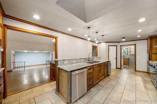 kitchen featuring appliances with stainless steel finishes, ornamental molding, sink, hanging light fixtures, and an island with sink