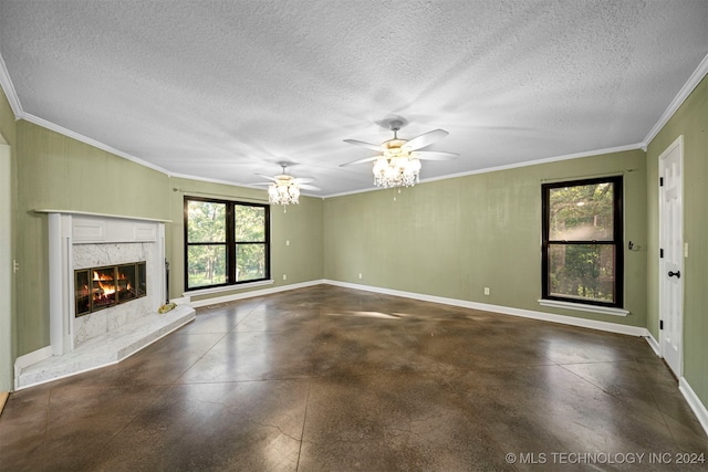 unfurnished living room featuring ceiling fan, a high end fireplace, a textured ceiling, and ornamental molding