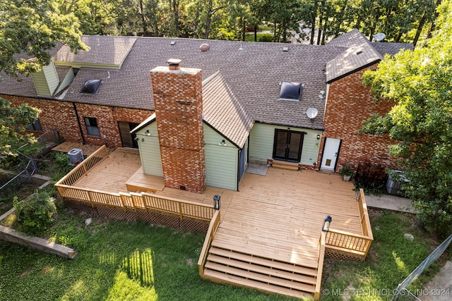 back of house featuring french doors, a yard, and a wooden deck