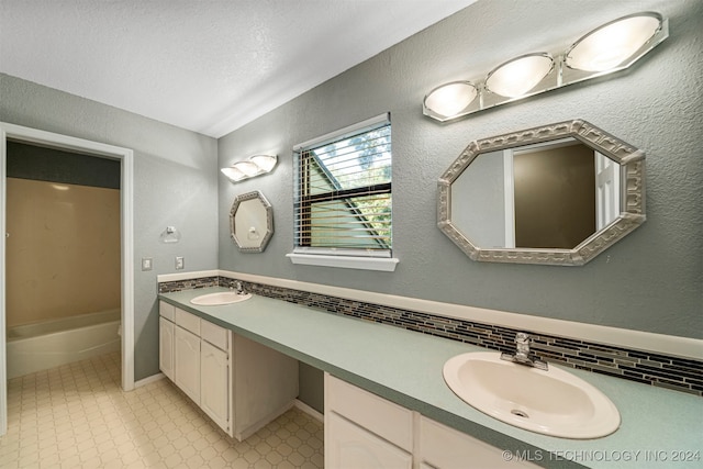 bathroom with vanity and decorative backsplash