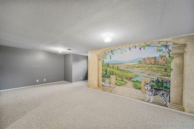 unfurnished room with carpet and a textured ceiling