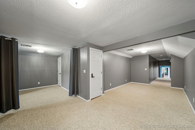 bonus room featuring light carpet, a textured ceiling, and vaulted ceiling