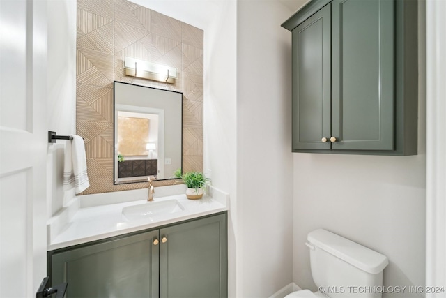 bathroom featuring toilet and vanity