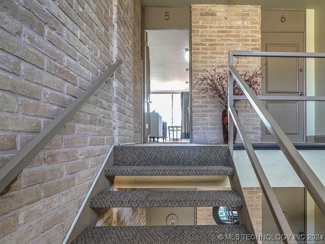 staircase with brick wall